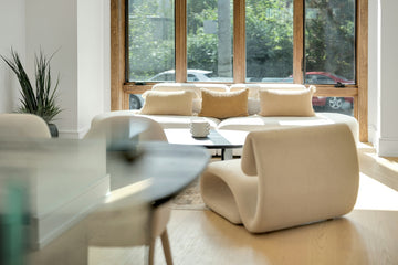 Modern living room with stylish furniture and large window.